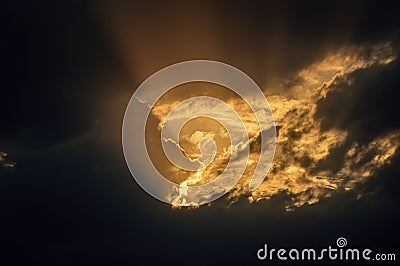 Rays of sun coming out of dark clouds Stock Photo