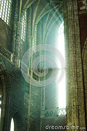 Sunlight crossing through a big window or showcase inside of Saint Bavo Cathedral Sint-Baafskathedraal in Ghent, Belgium Stock Photo