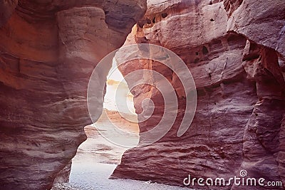 sunlight makes it way through the rocks of the great red canyon in Eilat in Israel Stock Photo