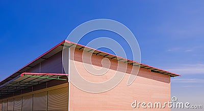 Orange brick pattern of prefabricated smartboard wall with roller shutter doors and steel roof awning of rental shophouse Stock Photo