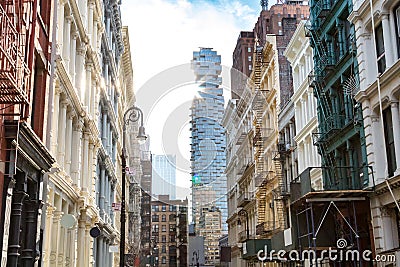 Sunlight shines on the buildings along Greene Street in New York City Stock Photo