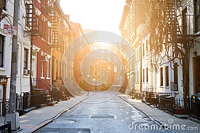 Sunlight shines on historic buildings along Gay Street in New York City Stock Photo