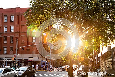 Sunlight shining on the busy intersection on Clinton Street in the Lower East Side of New York City Stock Photo