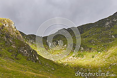 Sunlight on the steep sides of Corrie Fee, a Glacial Corrie in the heart of the Angus Glens. Stock Photo