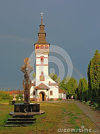 Orthodox assumption church with cross in front in ORastie, Romania Stock Photo