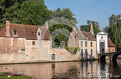 Sunlit Beguinage wall and entrance, Bruges, Belgium Stock Photo