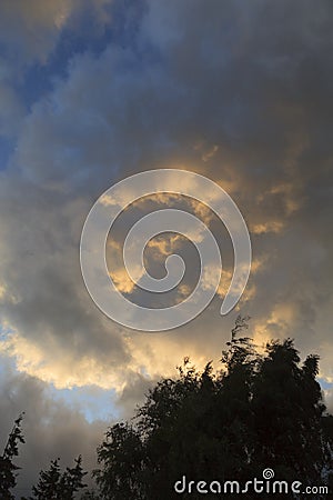 Sunlit clouds at Dusk Stock Photo