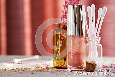 Sunlit cosmetics glass jars with lip gloss, cotton buds and decorative lilac Stock Photo
