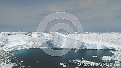 Sunlit icebergs in Antarctica ocean. Aerial. Stock Photo