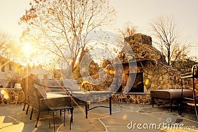 Sunlit Patio With Stone Fireplace Stock Photo