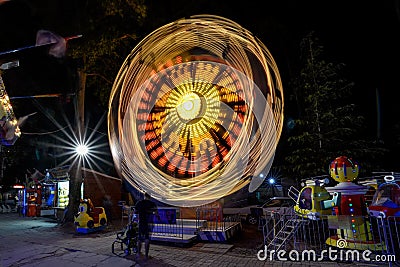 SUNNY BEACH, BULGARIA - September 10, 2017: Attraction in the park. Carousel in motion at night. A long exposure photo Editorial Stock Photo