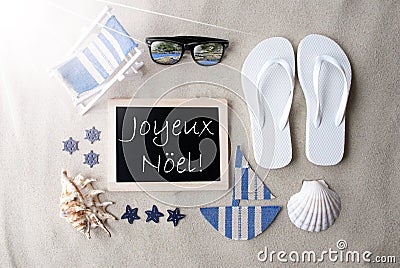 Sunny Blackboard On Sand, Joyeux Noel Means Merry Christmas Stock Photo