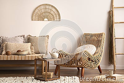 Sunny and bright composition of meditation living room interior with armchair, beige carpet, pillows, ornament and personal Stock Photo