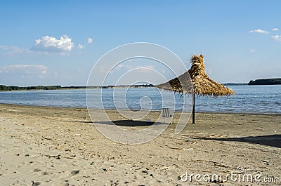 Sunny day on the beaches whit single umbrella made from reed or cane Stock Photo