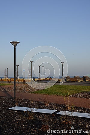 Sunny day with green grass and blue sky. Young trees. Reidi tee promenade. Modern space for walking and rest in a city Stock Photo