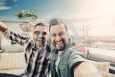 Cheerful friends at outdoor cafe making selfie Stock Photo