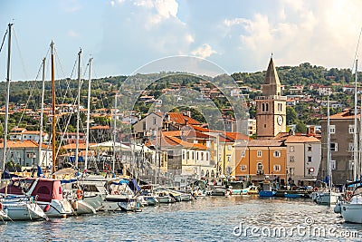 Sunny day in harbor. View of yachts moored in a small coastal town Muggia Editorial Stock Photo