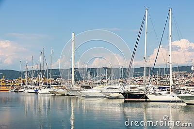 Sunny day in harbor. View of yachts moored in a small coastal town Muggia Editorial Stock Photo