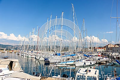 Sunny day in harbor. View of yachts moored in a small coastal town Muggia Editorial Stock Photo