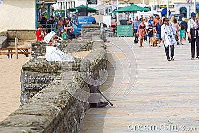 Elderly Sikh gentleman people watching, chilling, sat on a bench at Weston seafront. Editorial Stock Photo