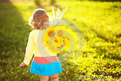 Happy child with bouquet of beautiful sunflowers. Stock Photo