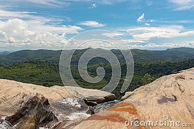 Sunny day in the Tropical waterfall falls from the mountain cliff to the jungle, serene landscape of Diyaluma falls. Editorial Stock Photo