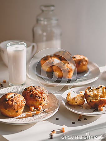 Sunny morning breakfast caramel and chocolate muffins with glass of milk Stock Photo