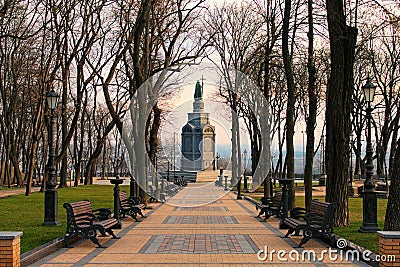 Sunny morning landscape view of the Monument of Volodymyr The Great. Straight stone walkway in the park. Stock Photo