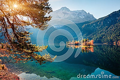 Sunny morning scene of Eibsee lake with Zugspitze mountain range on background. Beautifel autumn sunrise of Bavarian Alps, Germany Stock Photo
