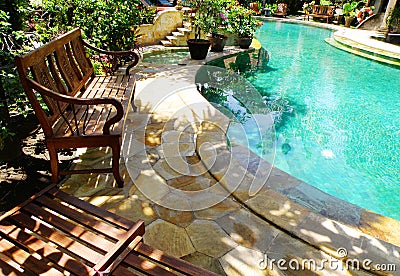 Sunny outdoor swimming pool and patio furniture Stock Photo