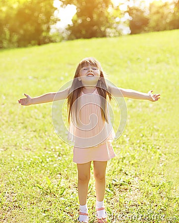 Sunny photo happy little girl child enjoying summer day Stock Photo