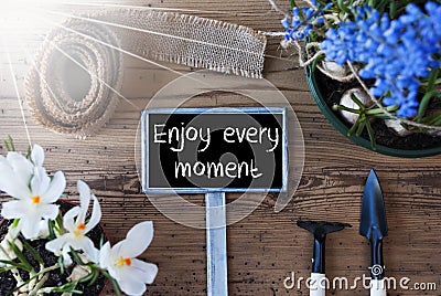 Sunny Spring Flowers, Sign, Quote Enjoy Every Moment Stock Photo