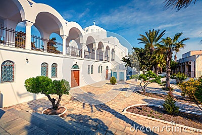 Sunny spring view of garden at Fira Orthodox Cathedral. Colorful morning scene of the famous Greek resort - Thira, Santorini, Stock Photo