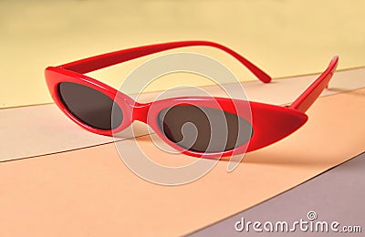 Sunny stylish glasses in bright red frames on a colored background, concept Stock Photo