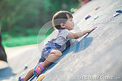 A lively little boy is playing a climbing game Stock Photo