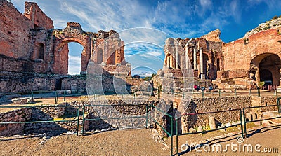 Sunny summer view of ruine of Greco-Roman theater, Sicily, Itale, Europe. Bright morning cityscape of Taormina town and Etna volca Stock Photo