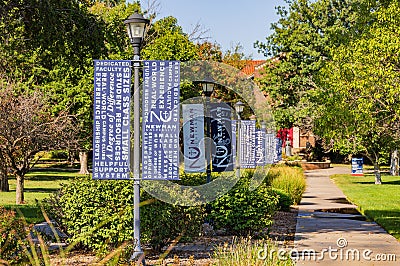 Sunny view of some flags in campus of Newman University Editorial Stock Photo