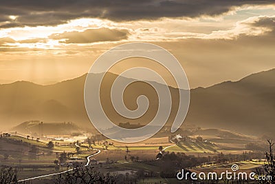Sunrays coming over a valley in Umbria Italy Stock Photo