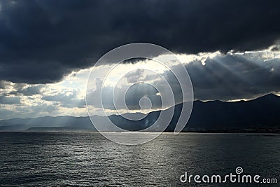 Sunrays through dramatic clouds Stock Photo