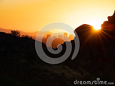 Sunrays and Phoenix Cityscape from Camelback Mountain in Arizona Stock Photo