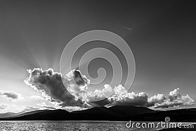 Sunrays shining through cloud over Montedoglio lake Tuscany, Italy Stock Photo