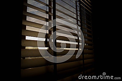 Sunrays shining trough some blinds Stock Photo