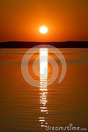 Sunrise above horizon forest at lake Stock Photo
