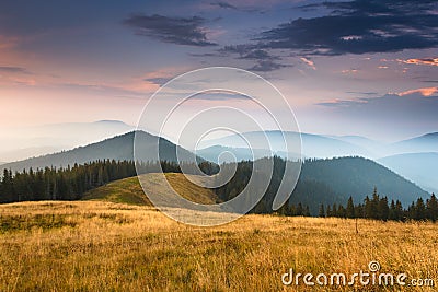 Sunrise above peaks of smoky mountain with the view of forest in the foreground. Stock Photo