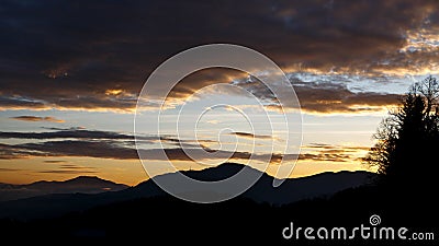 Sunrise in the austrian alps shining at mystic clouds up a sleeping valley in styria in the austrian alps Stock Photo