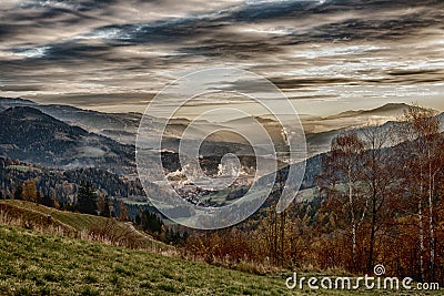 Sunrise in the austrian alps shining at a sleeping valley and mystic clouds in styria HDR Stock Photo