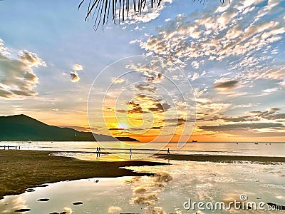 sunrise on the beach, Sunrise, At the break of dawn, the beach comes alive with a shimmering golden glow Stock Photo