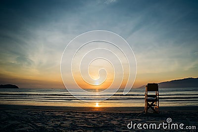 Sunrise on the beach with lifeguard stand Stock Photo