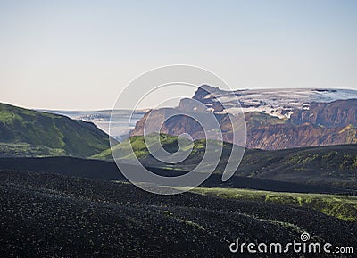 Sunrise at Botnar campsite at Iceland on Laugavegur hiking trail, green valley in volcanic landscape with view on Myrdalsjokull Stock Photo