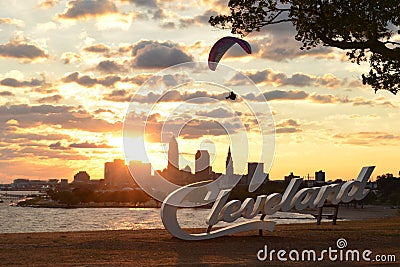 Sunrise with Cleveland skyline, Lake Erie, and paraglider Editorial Stock Photo